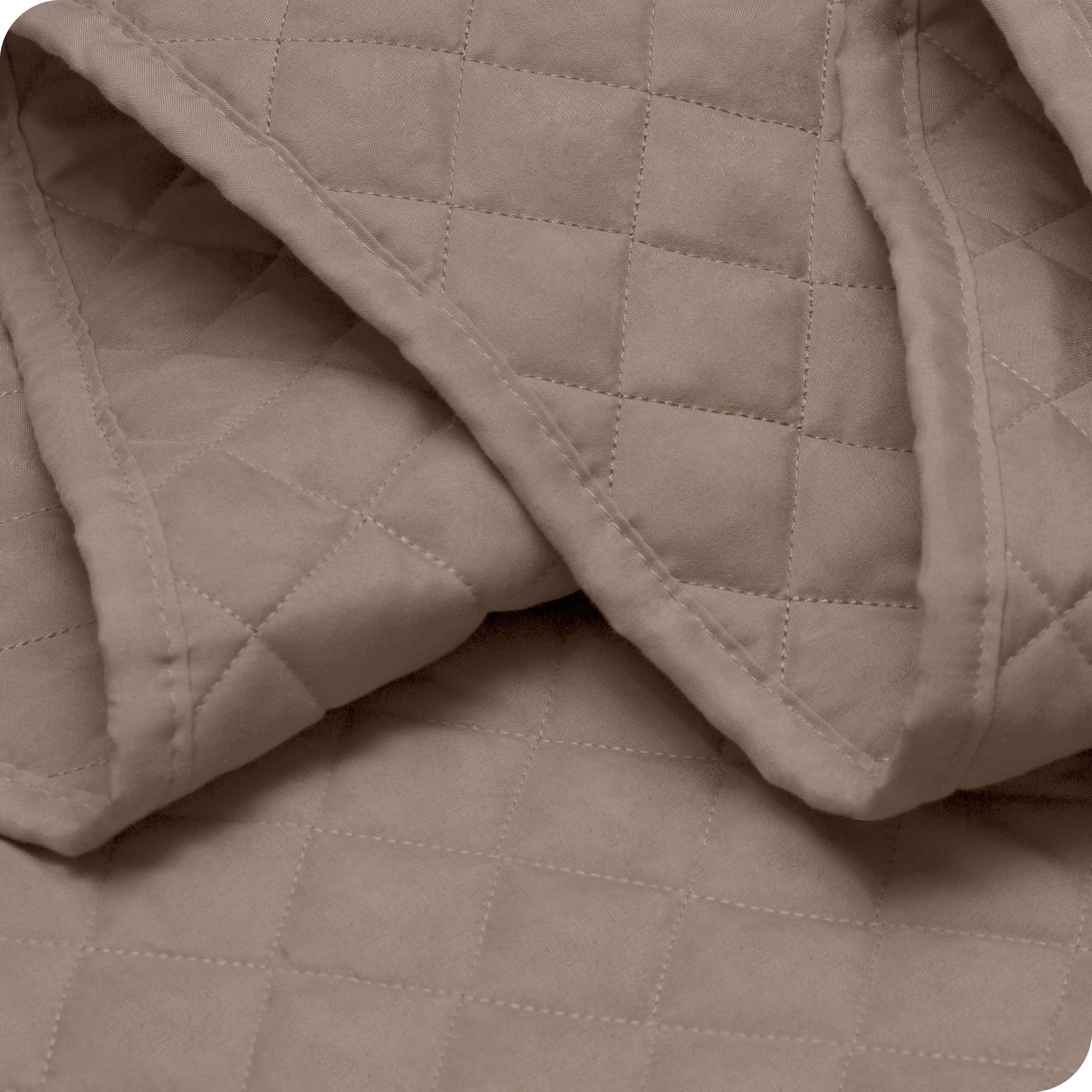 Close up of a coverlet showing the stitching
