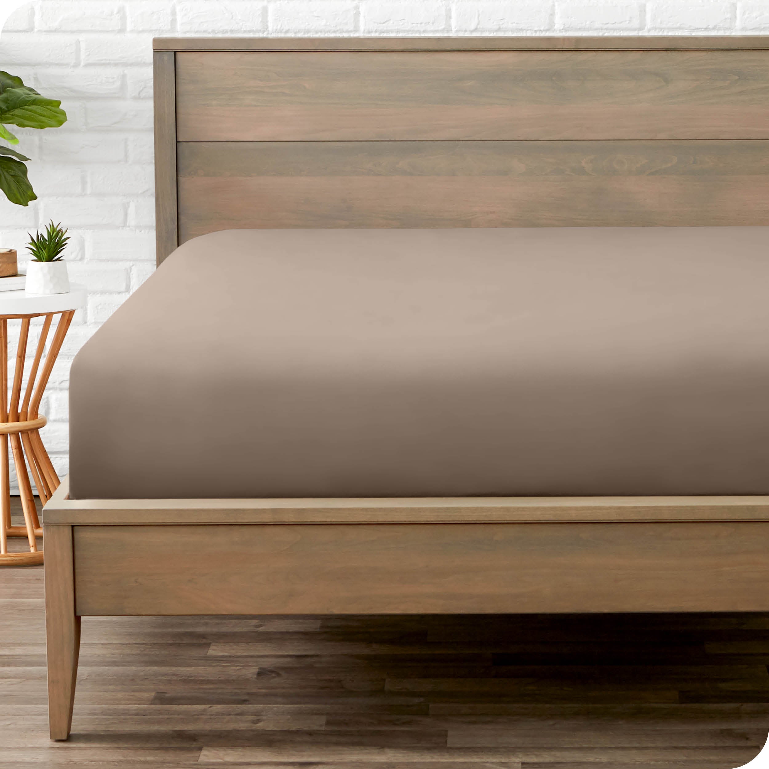 End of bed view with fitted sheet made on the mattress of a modern bed. 