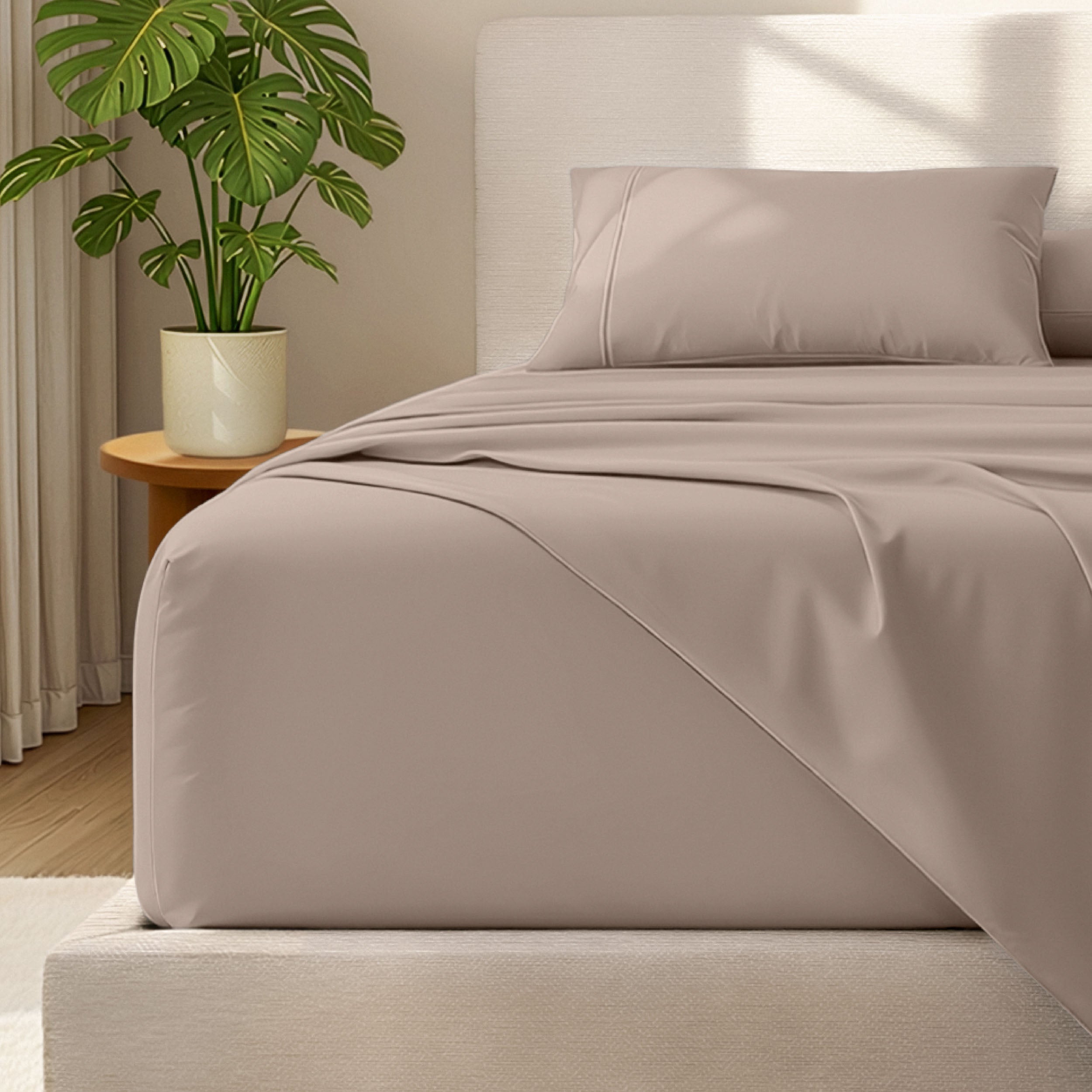 Microfiber bed sheets and pillowcases on a bed with a plant in the background