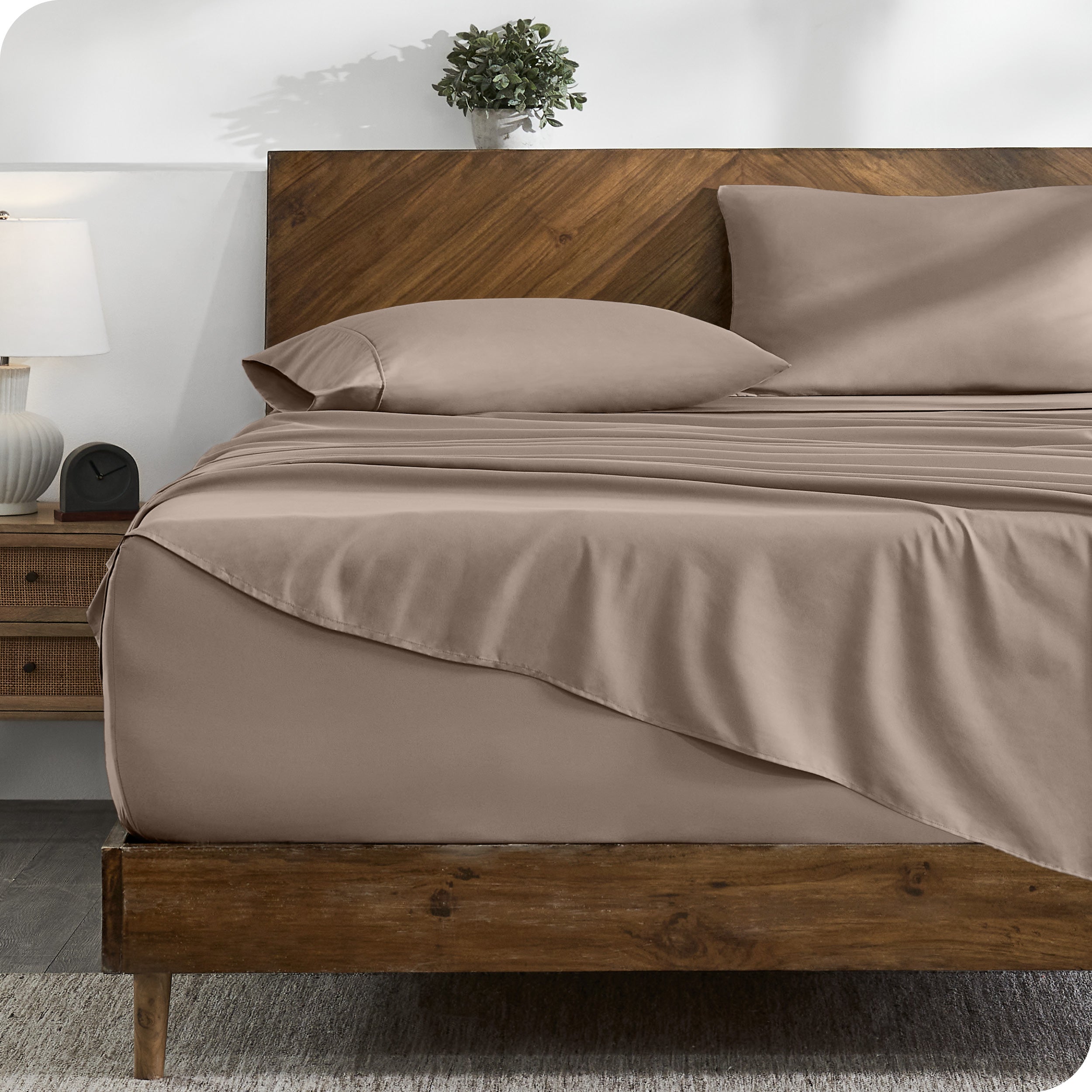 A cozy bedroom with a bed covered in soft microfiber sheets

