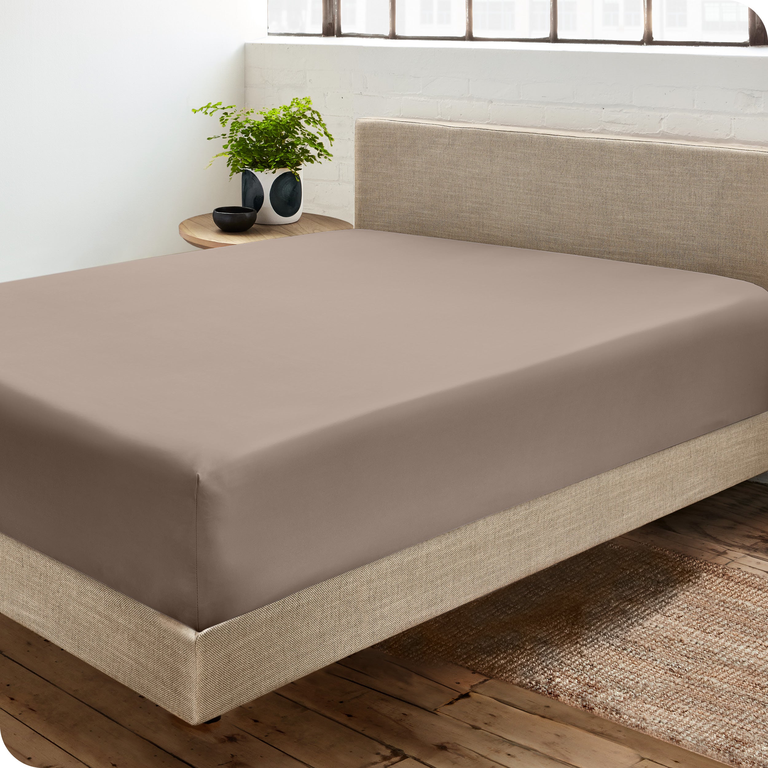 A sateen fitted sheet on a bed