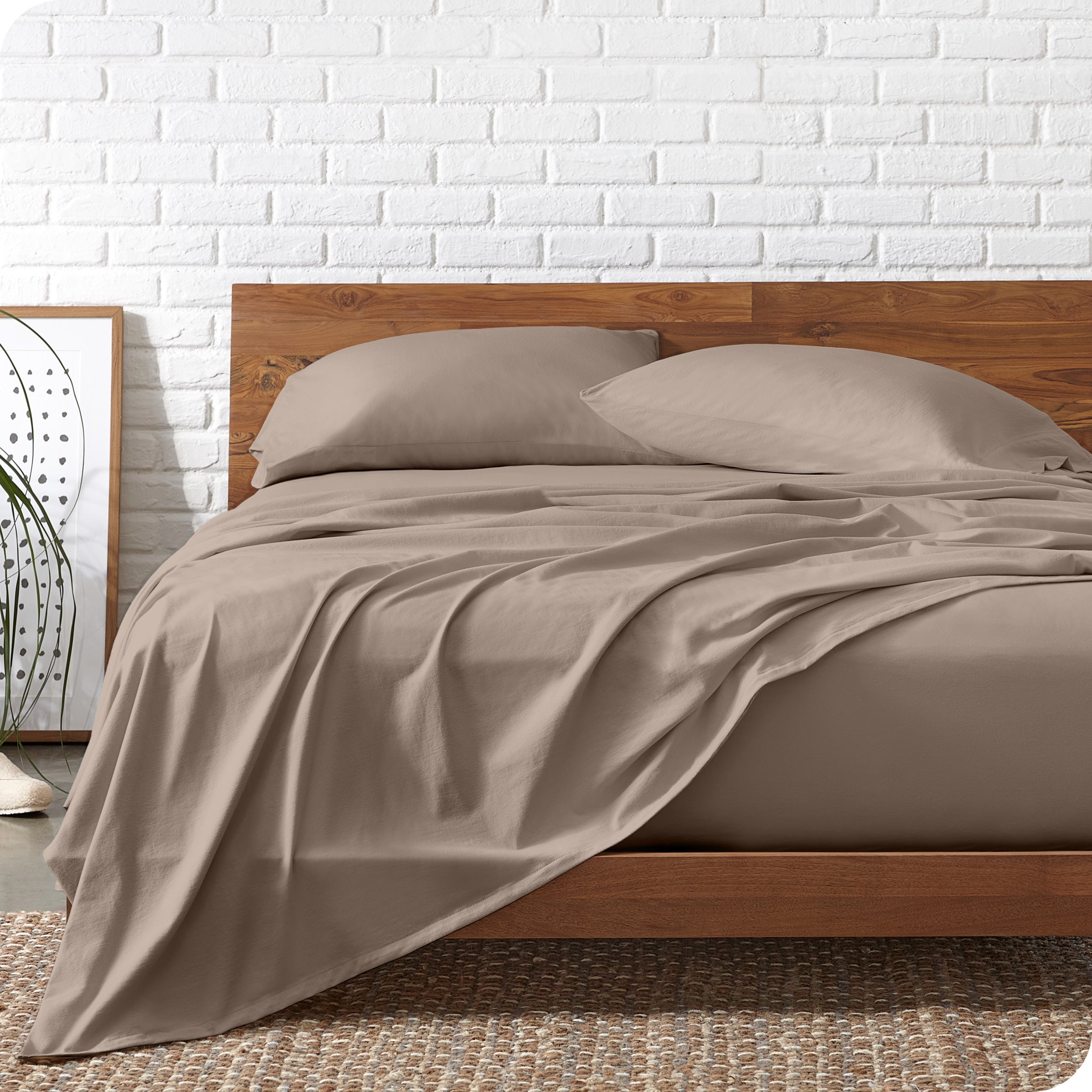Organic jersey sheets on a bed with a wooden bed frame