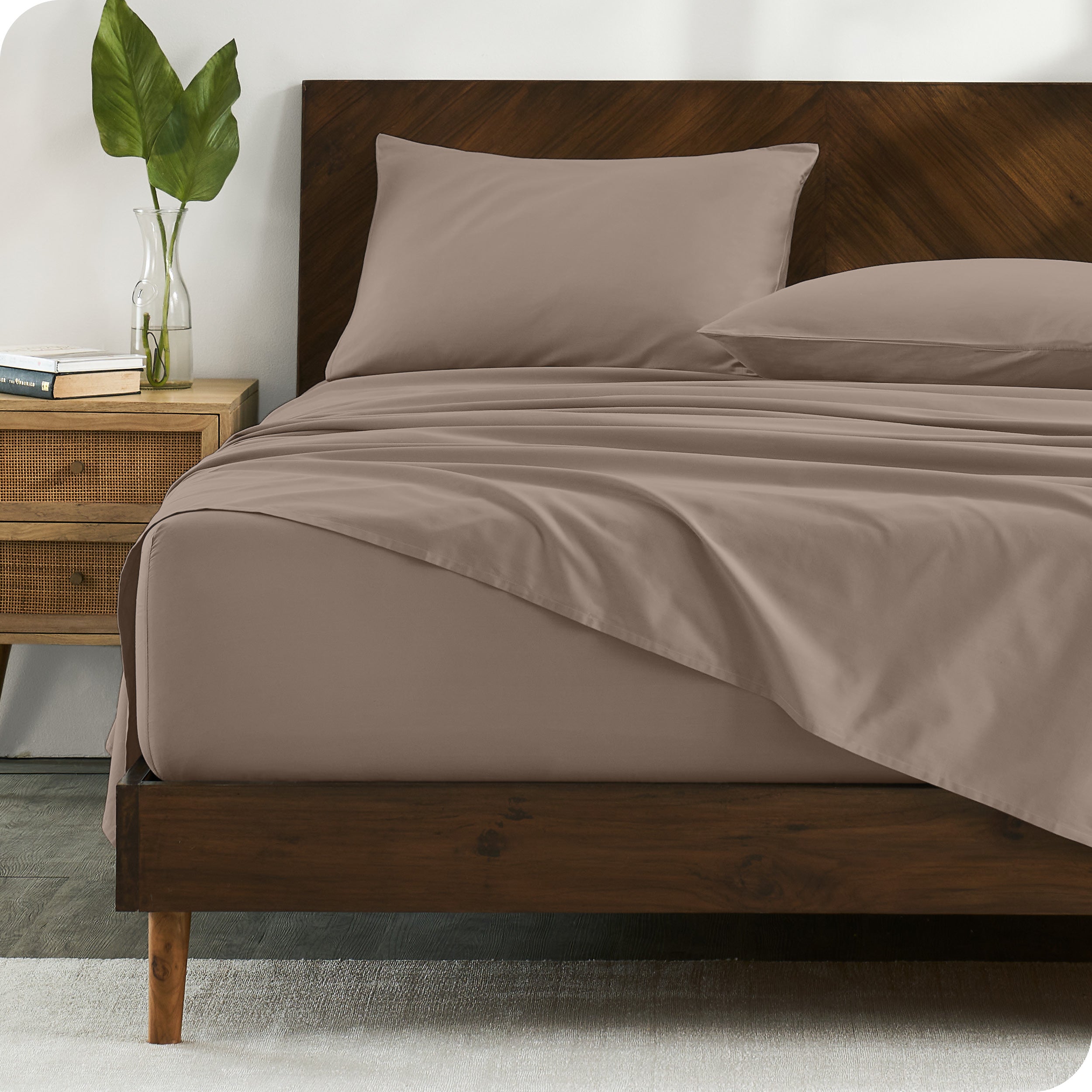 Percale sheets on bed in a modern bedroom