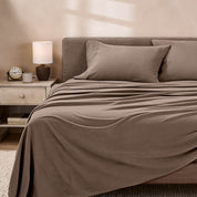 View of fleece sheets from the end of a bed with the top sheet draped over the side and end