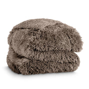 A shaggy faux fur blanket folded