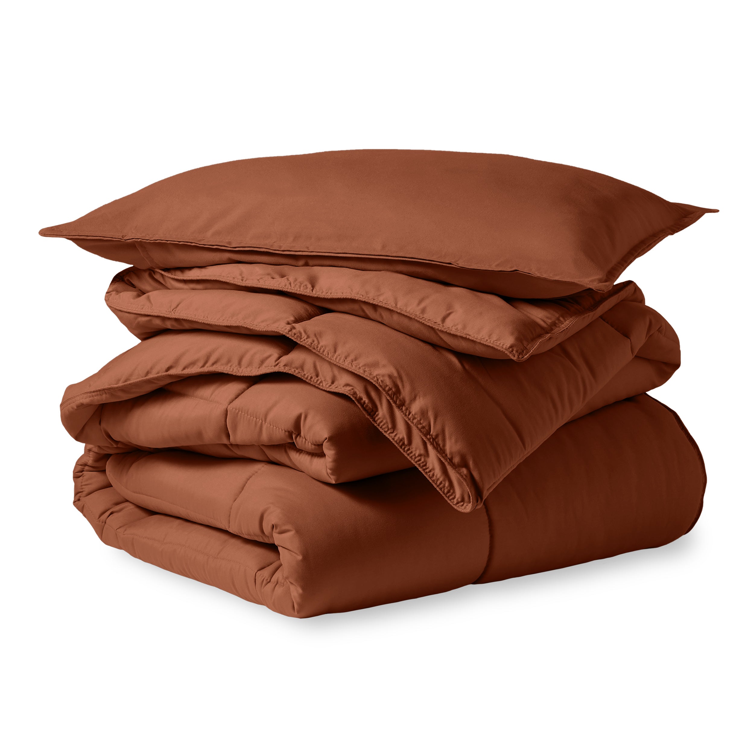 A microfiber comforter folded neatly with a pillow from above