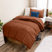 A modern bed with a down alternative comforter set on it