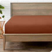 End of bed view with fitted sheet made on the mattress of a modern bed. 