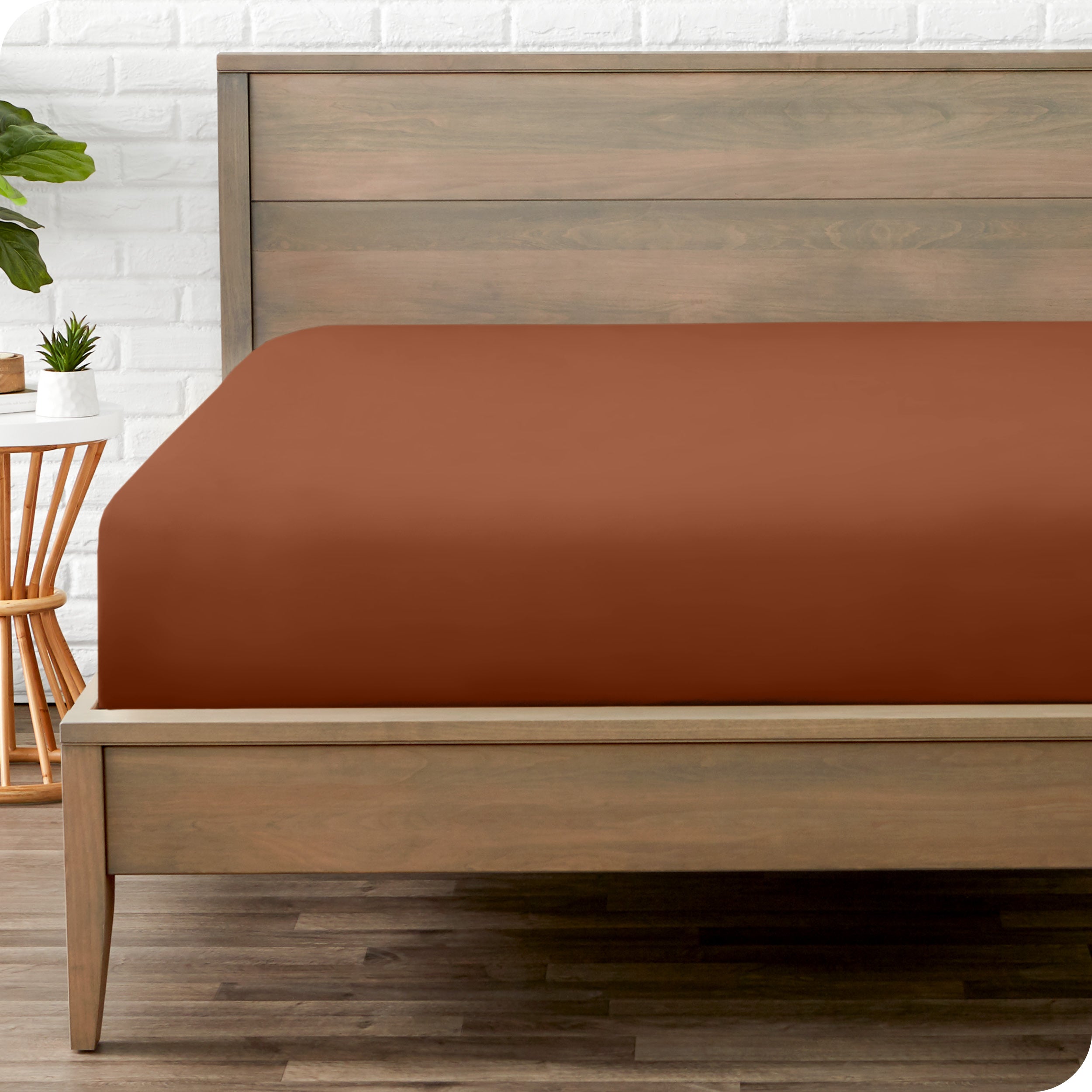 End of bed view with fitted sheet made on the mattress of a modern bed. 