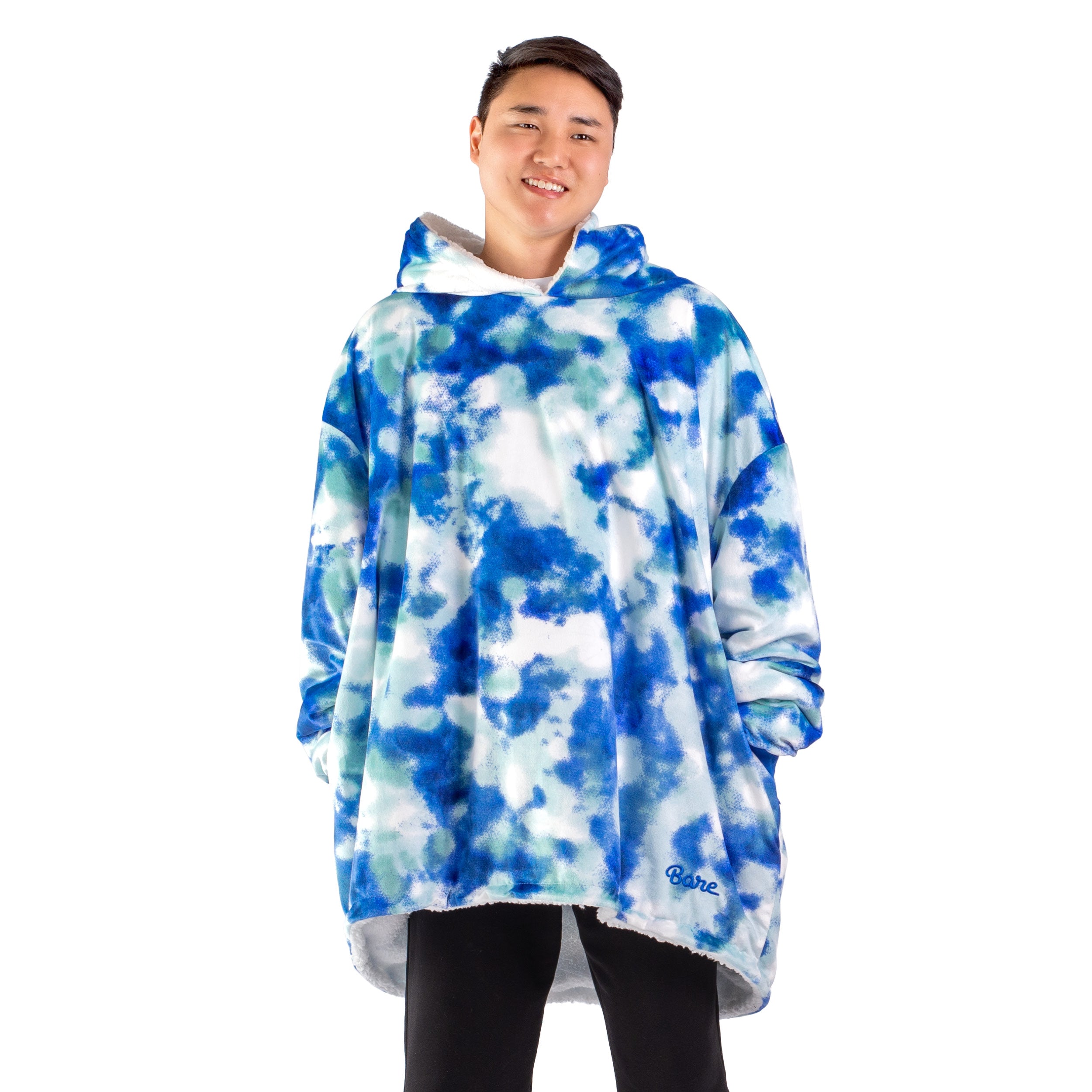 An adult with a sherpa wearable blanket on