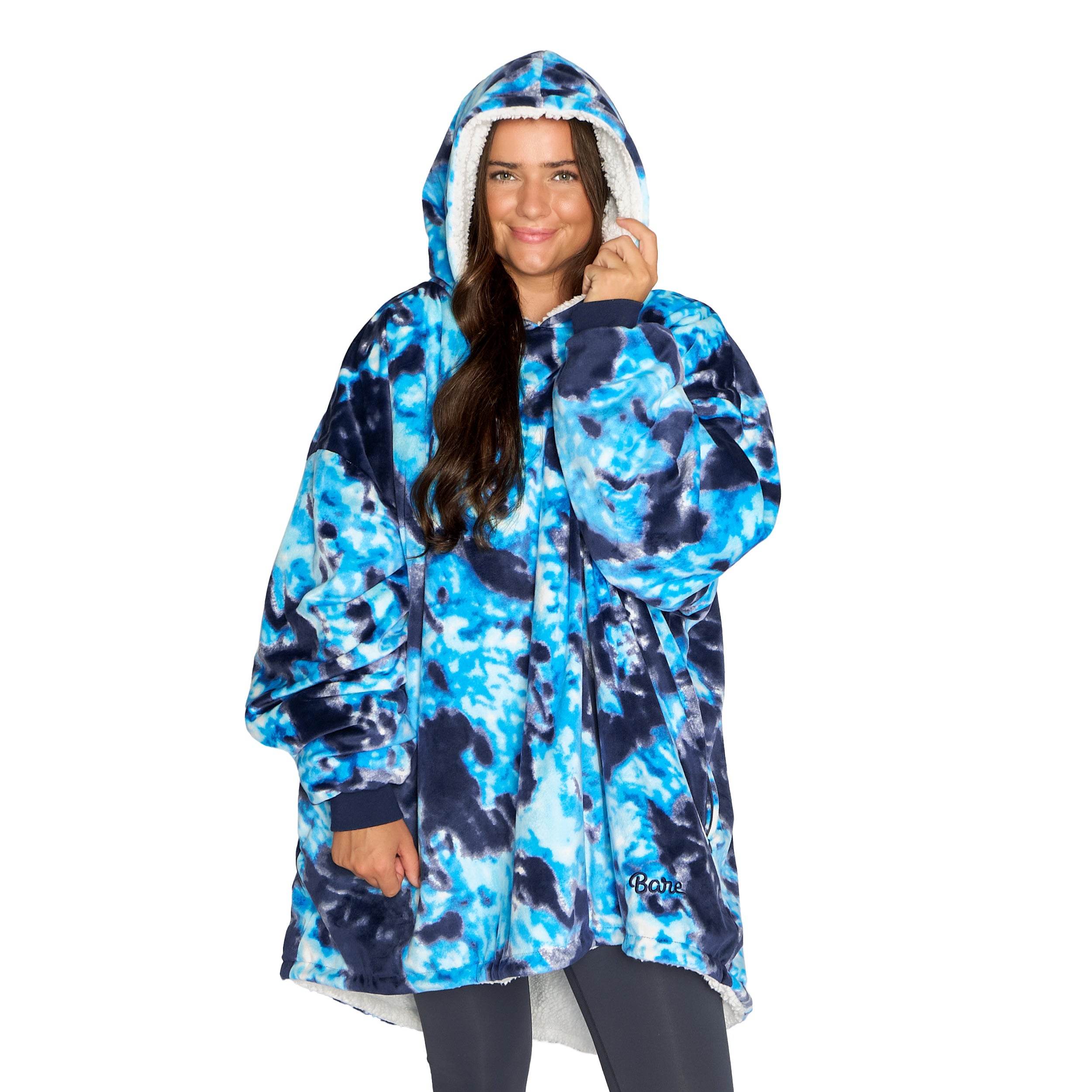 An adult with a sherpa wearable blanket on