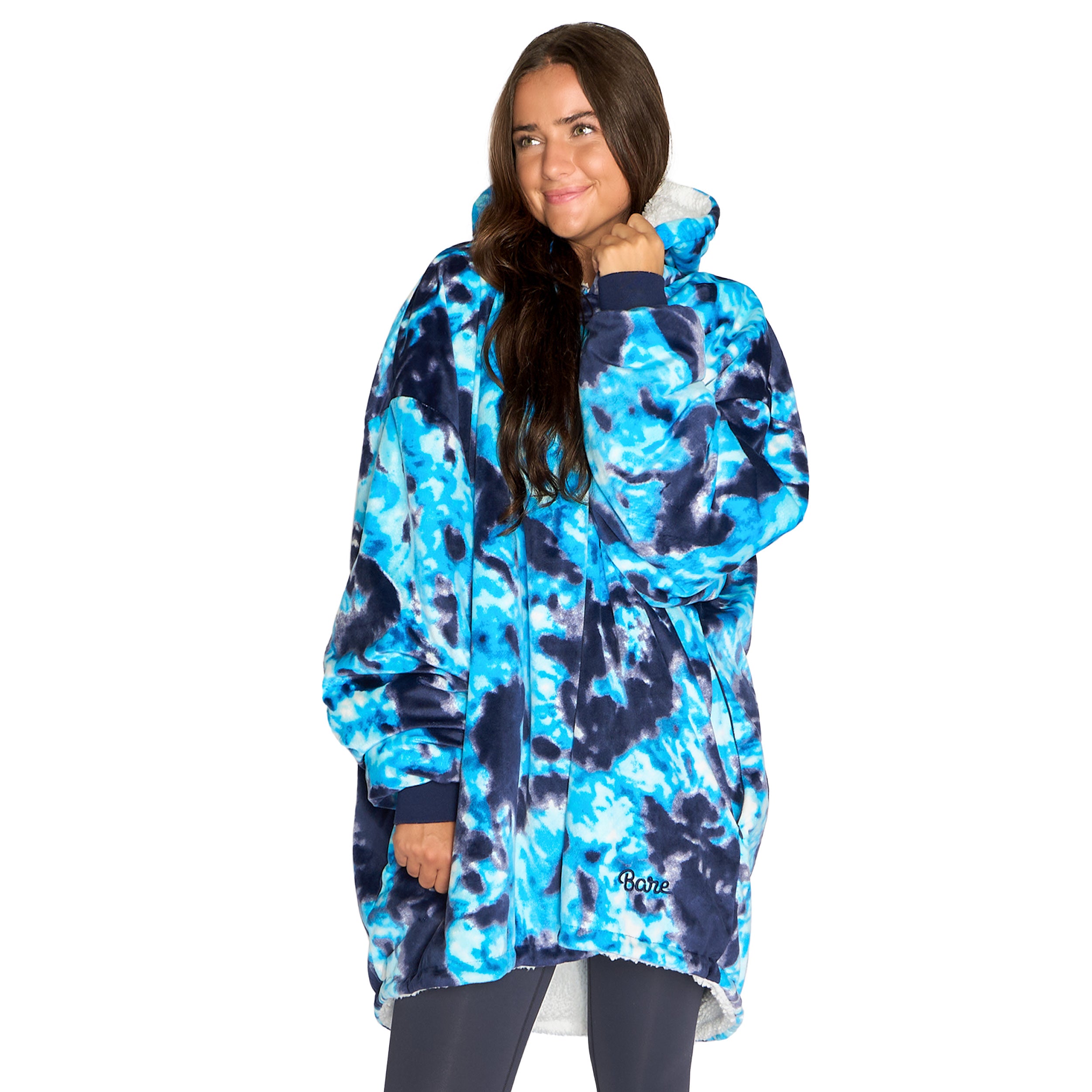 An adult with a sherpa wearable blanket on