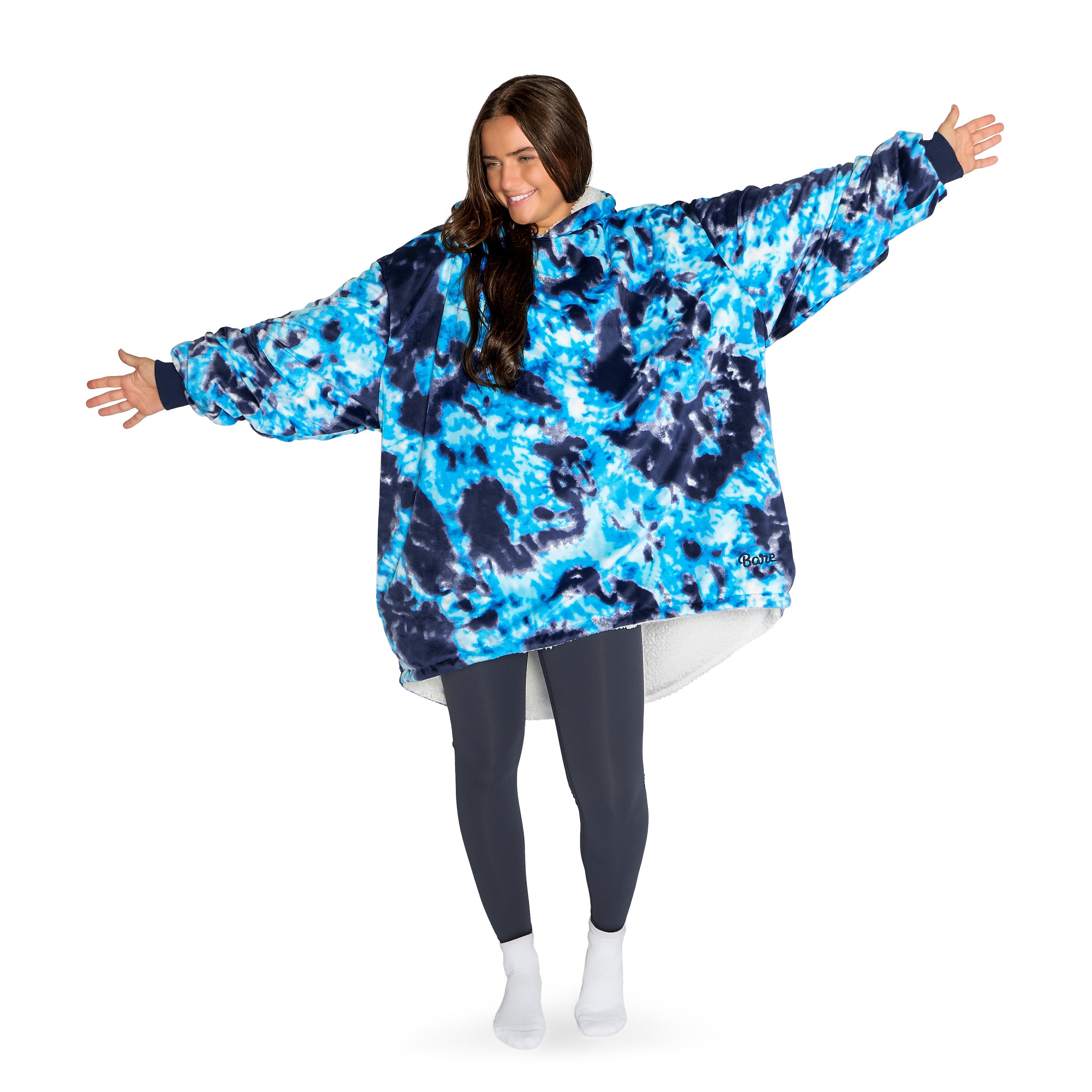An adult with a hooded wearable blanket on
