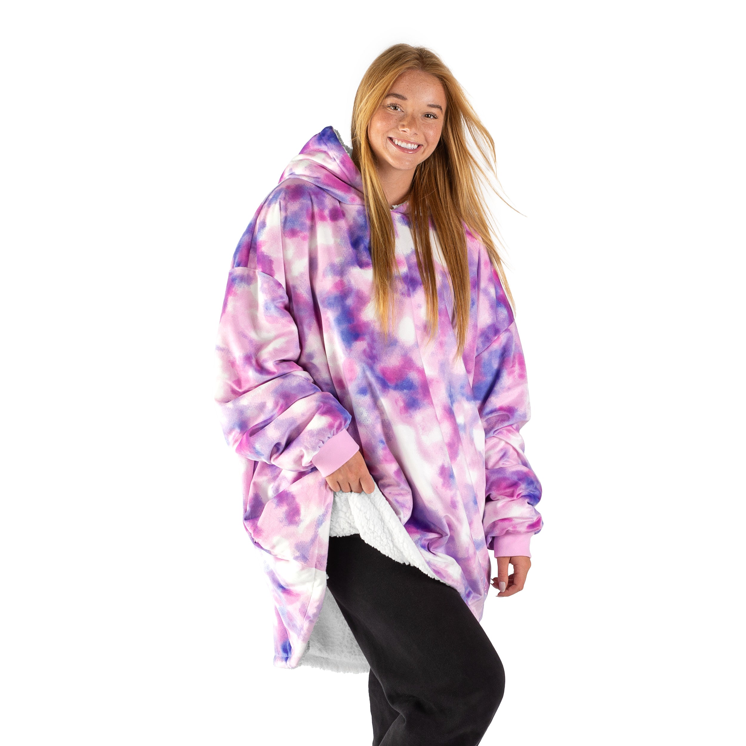 An adult with a sherpa wearable blanket on