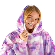 An adult with a sherpa wearable blanket on