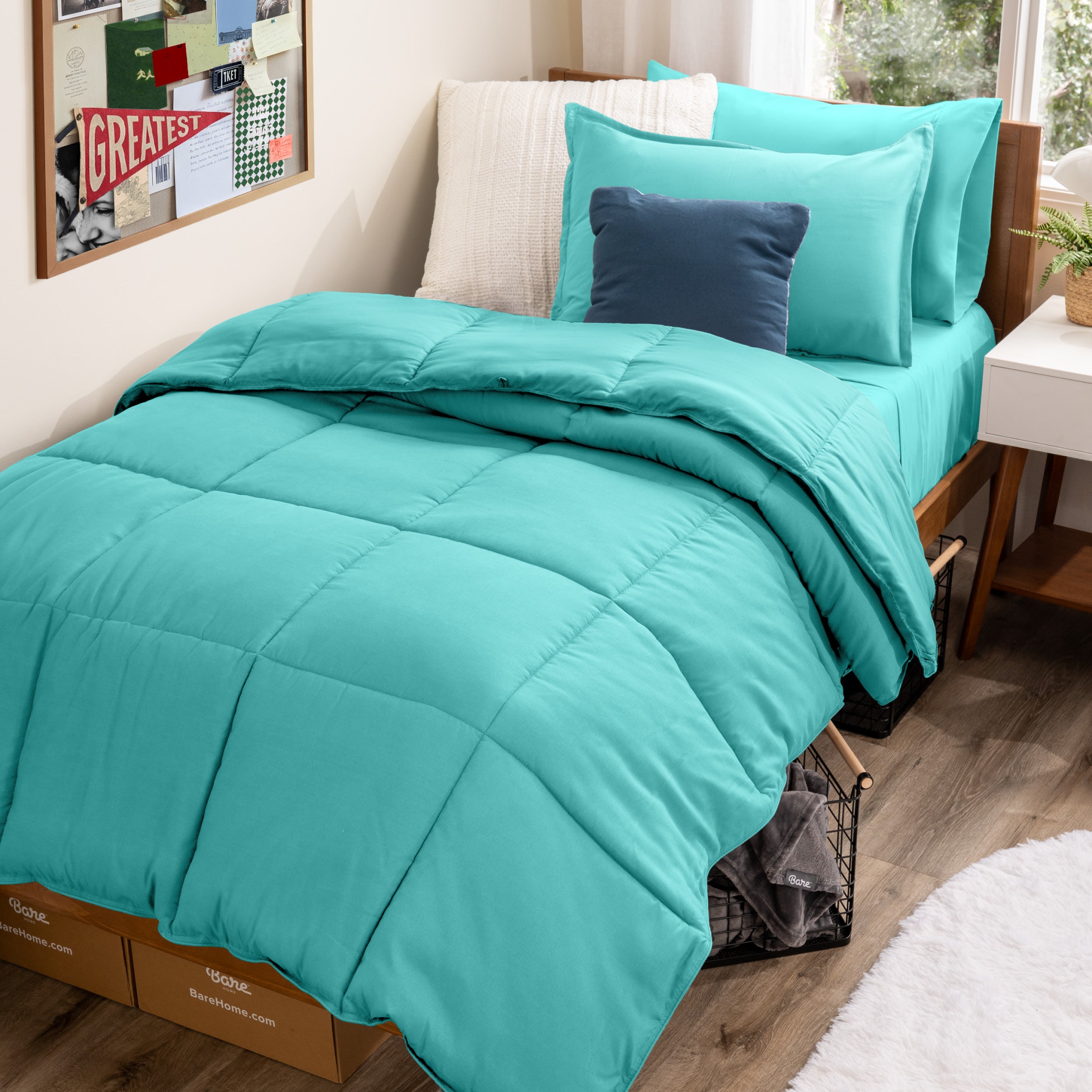 A college dorm room with a bed in a bag set on the mattress