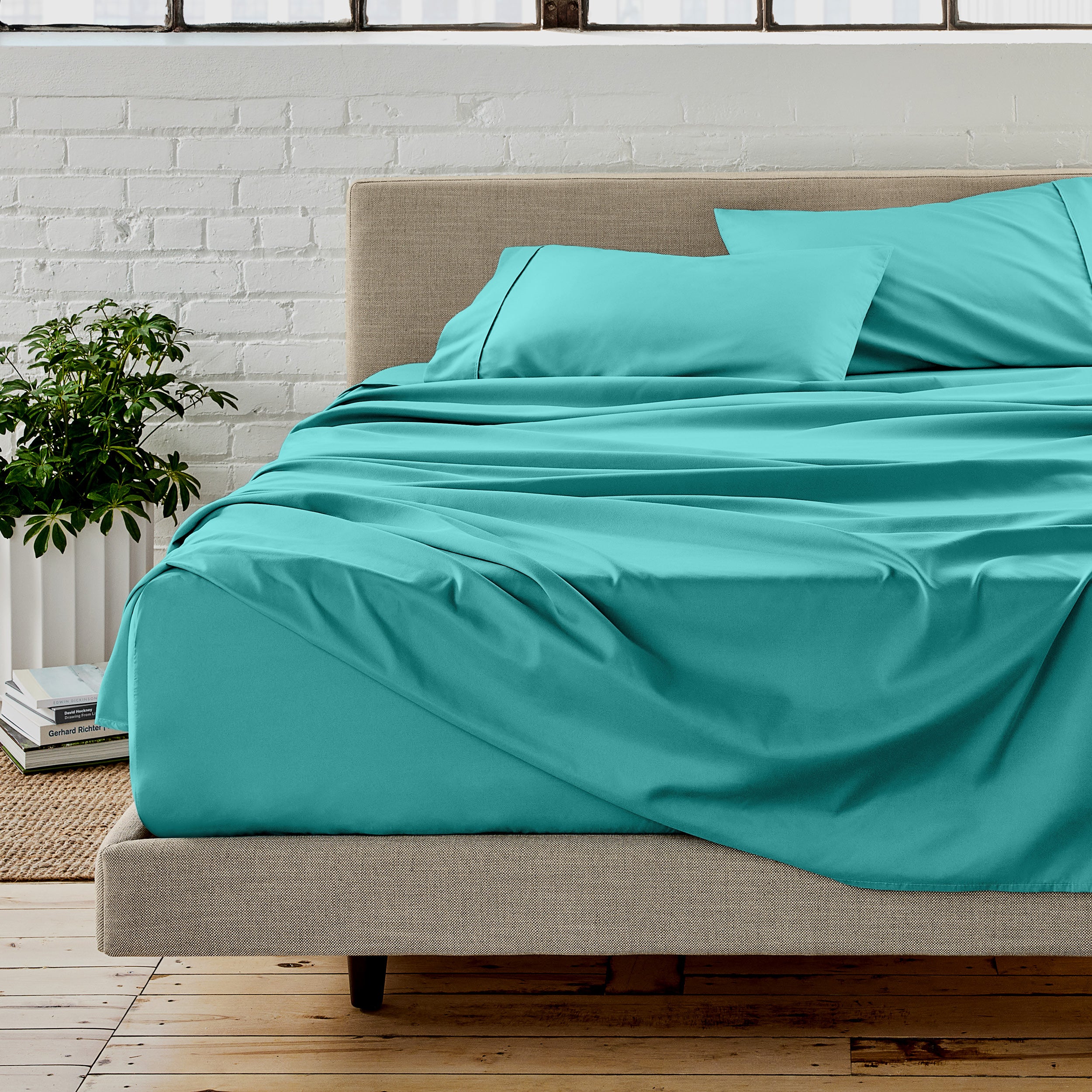 Microfiber sheet set on a bed with a white brick wall in the background