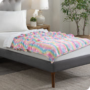 A weighted blanket laid out on a bed
