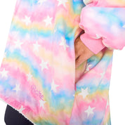 An adult with a hooded wearable blanket on