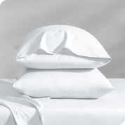 2 percale pillowcases on pillows set on a bed with matching sheets