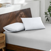 2 pillows with percale pillowcases on a bed