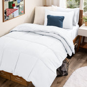 A college dorm room with a bed in a bag set on the mattress