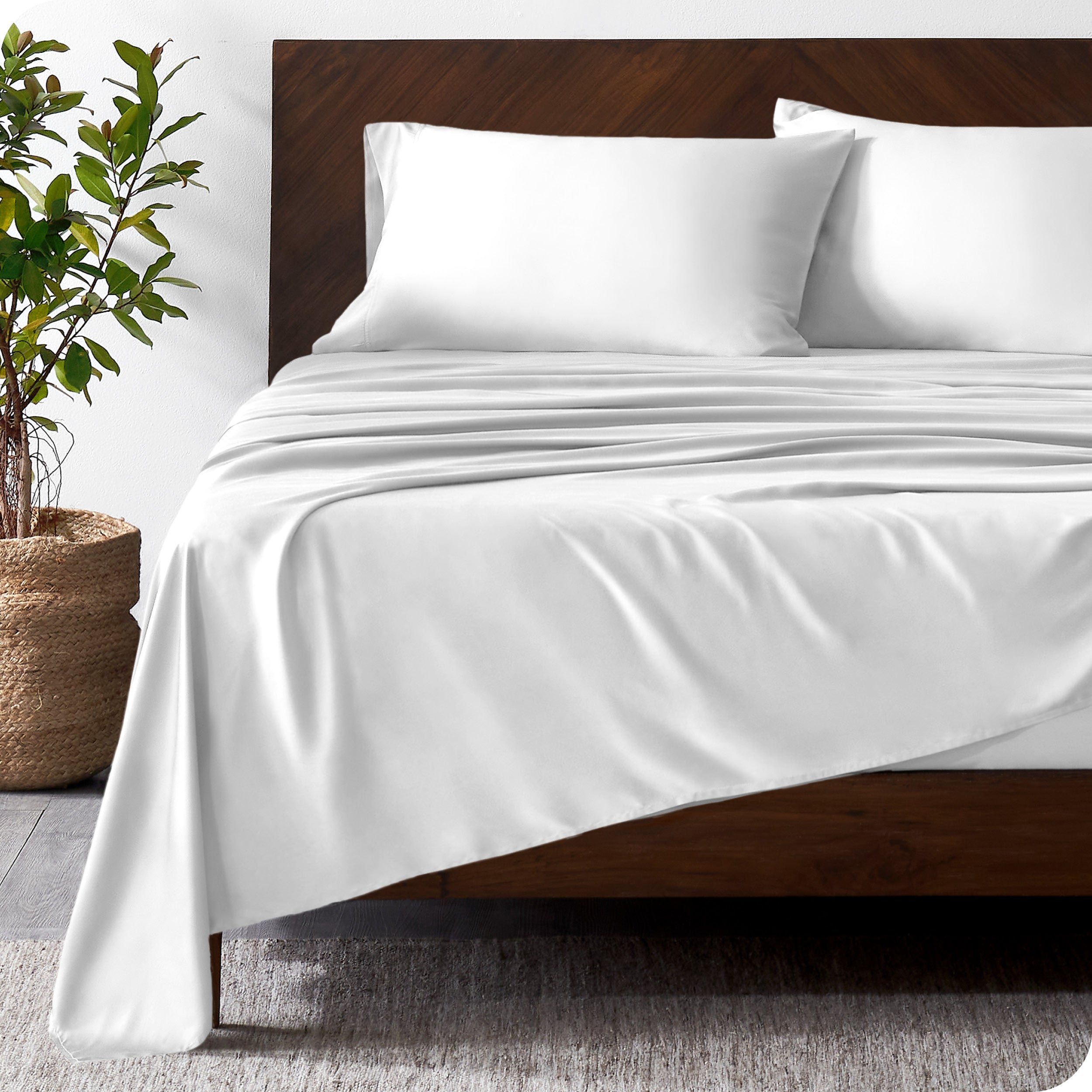 Wooden bed frame with bamboo sheets on the bed