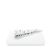 Fitted sheet neatly folded on a white background