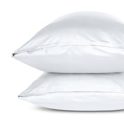 Two pillows with pillowcases stacked on a white background