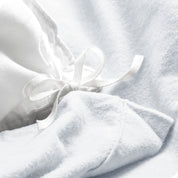 A folded stack of a flannel duvet cover with two pillows on top.
