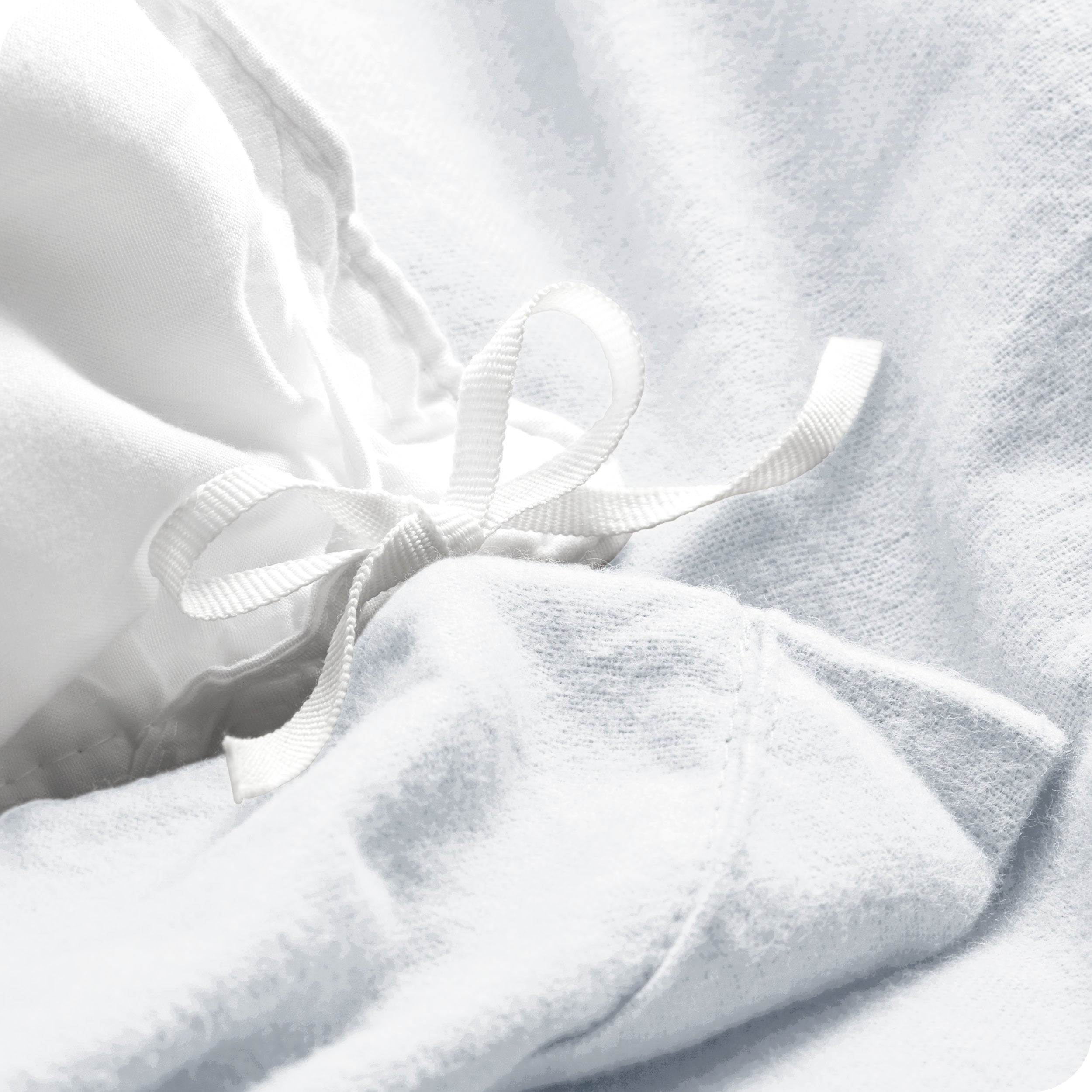 A folded stack of a flannel duvet cover with two pillows on top.