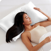 A woman sleeping with her head on a pillow with a silk pillowcase on it