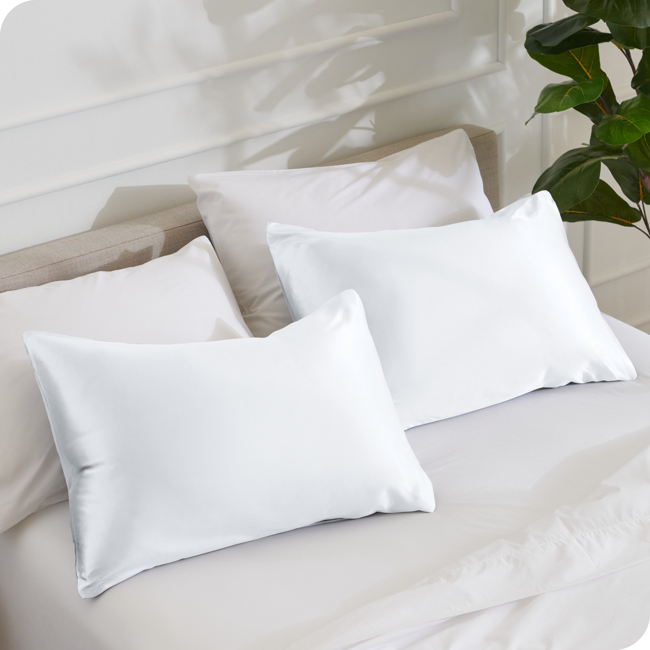 2 pillows with silk pillowcases on a bed