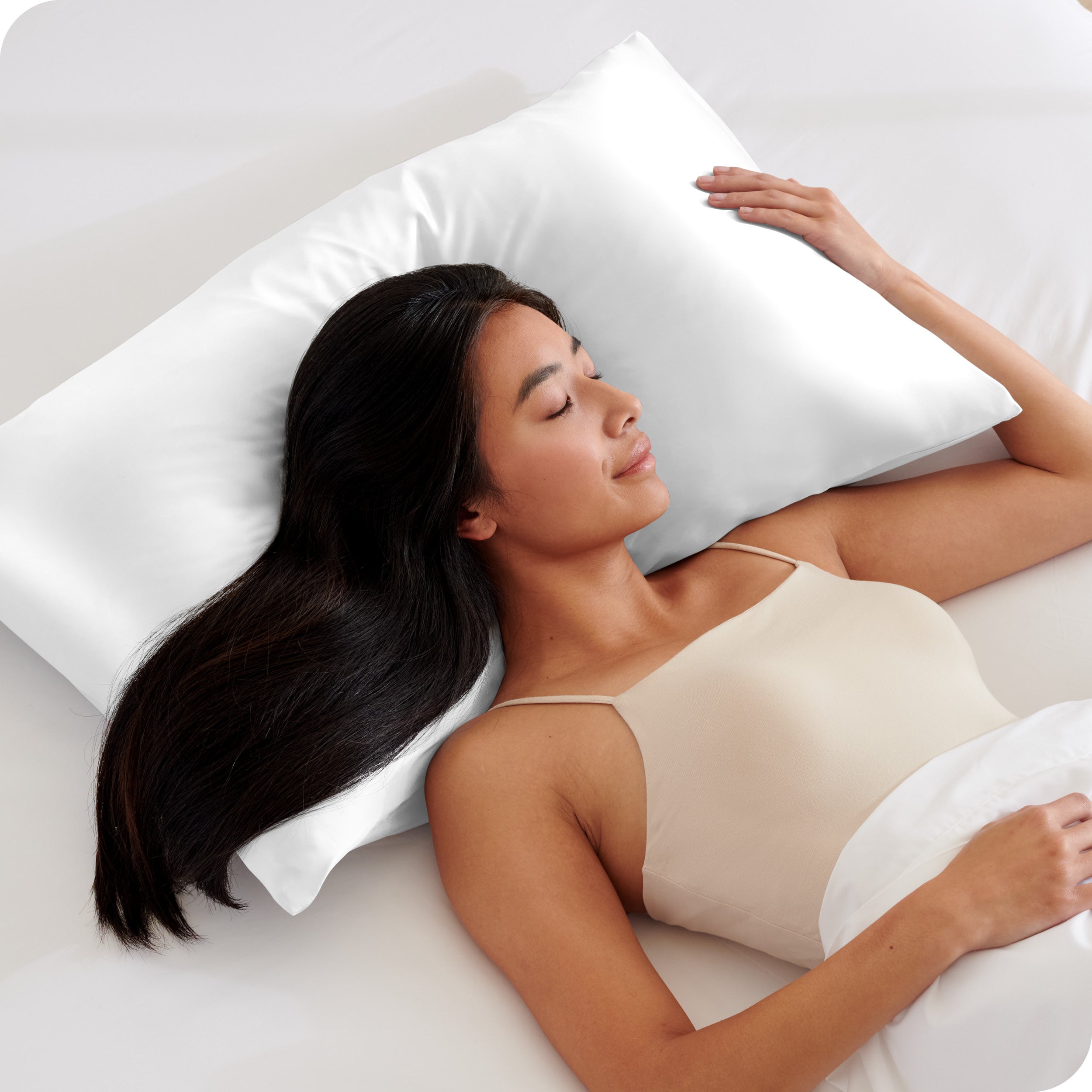 A woman sleeping with her head on a pillow
