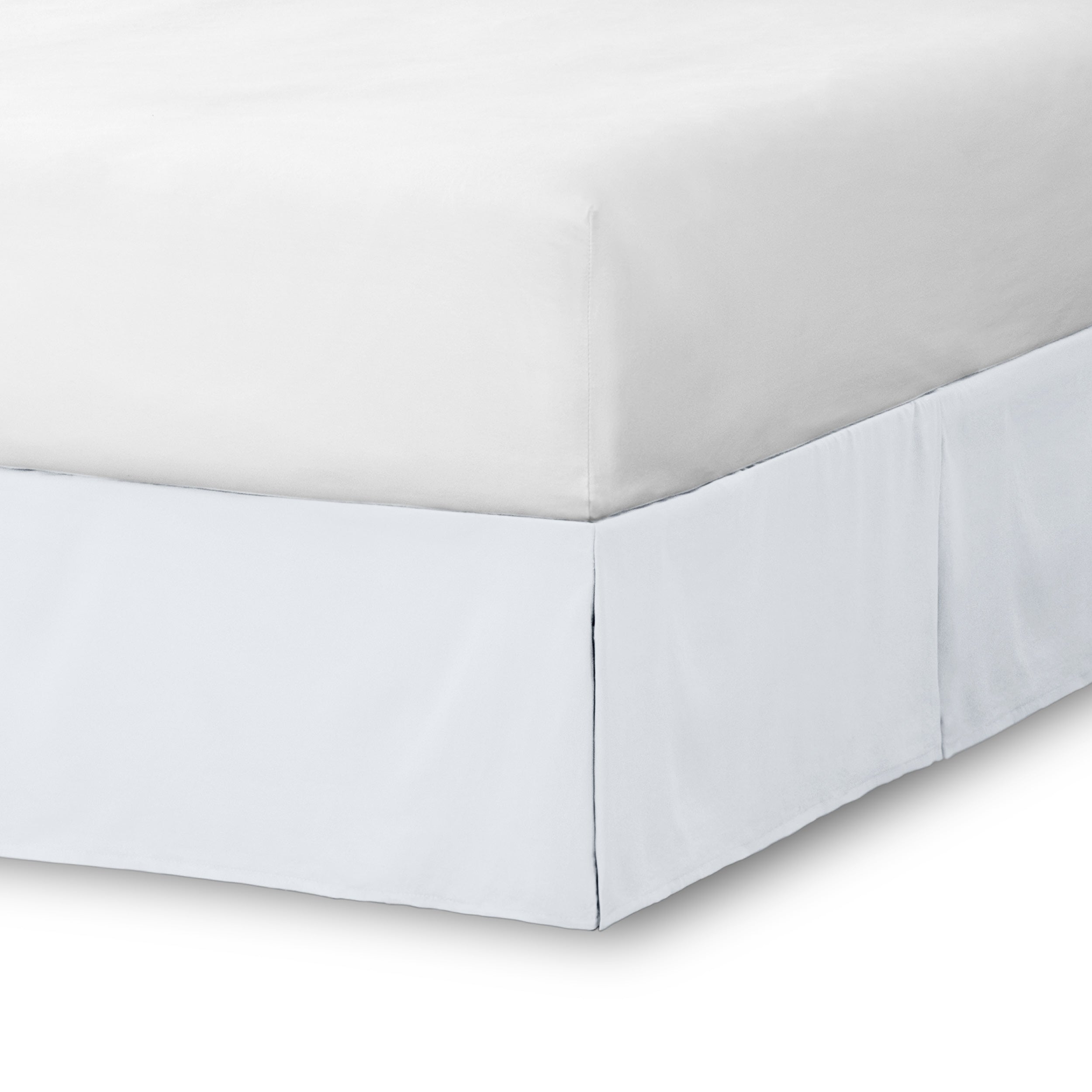 The corner of a bed skirt on a bed frame