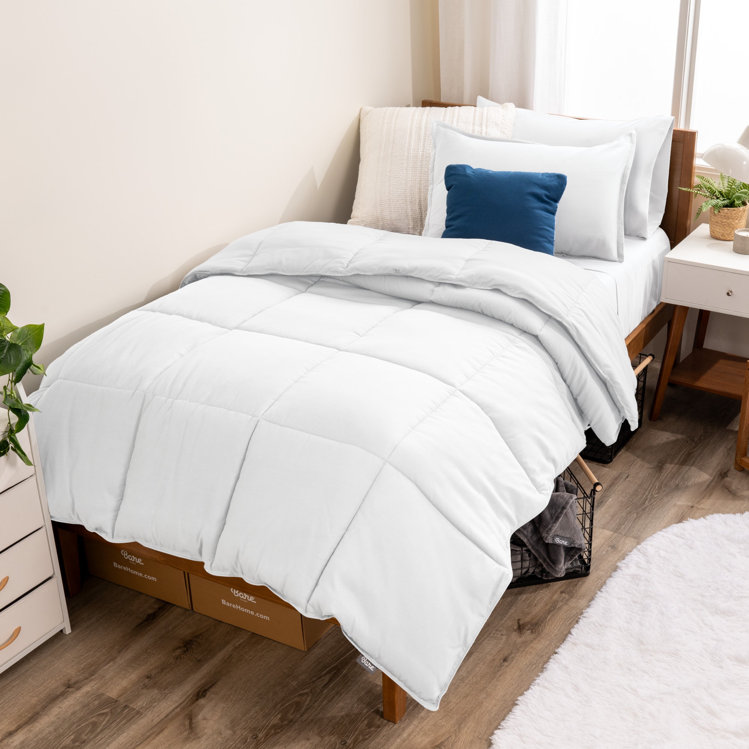 A modern bed with a down alternative comforter set on it