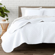 A quilted coverlet set on a bed