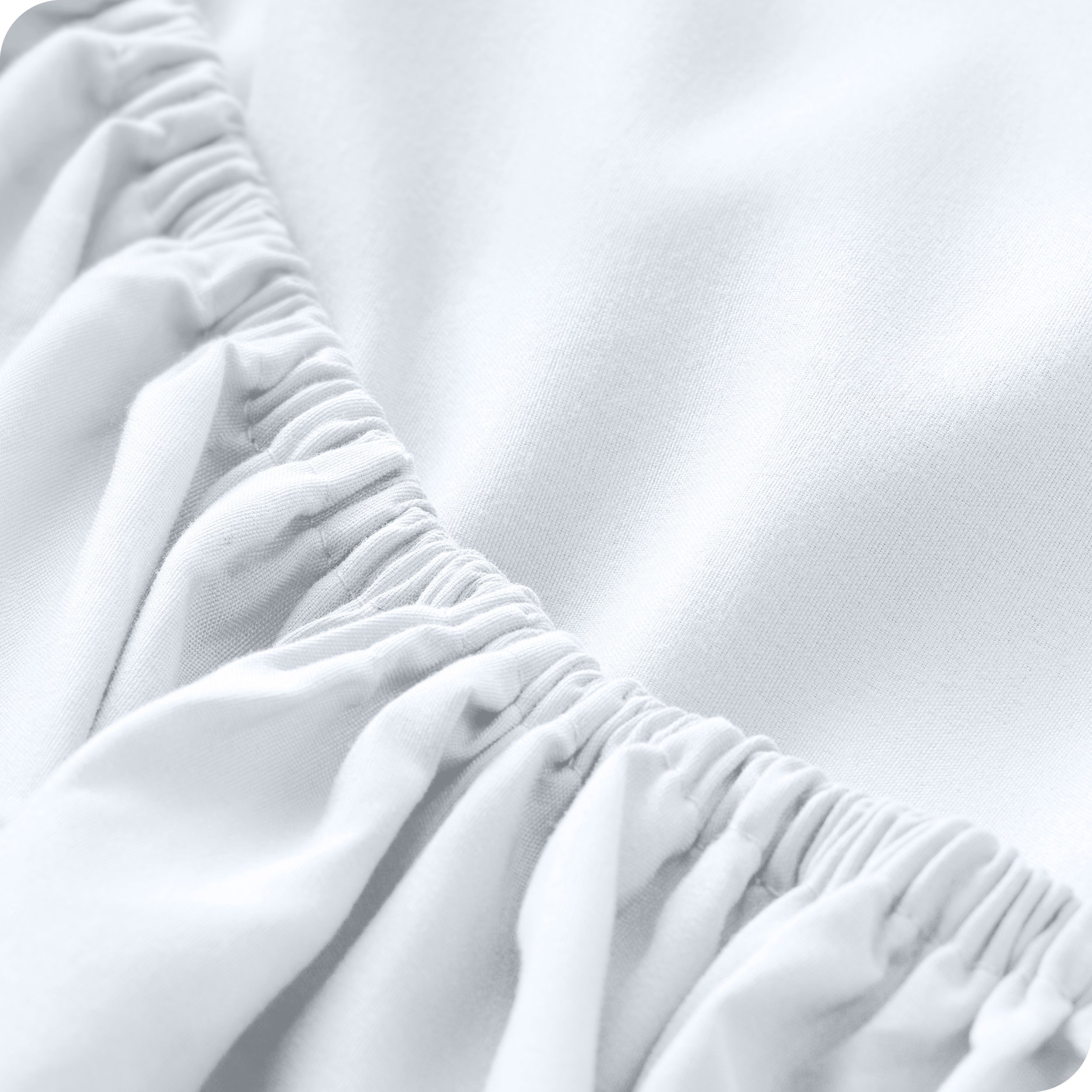 A close up of the elastic of a microfiber fitted sheet. 
