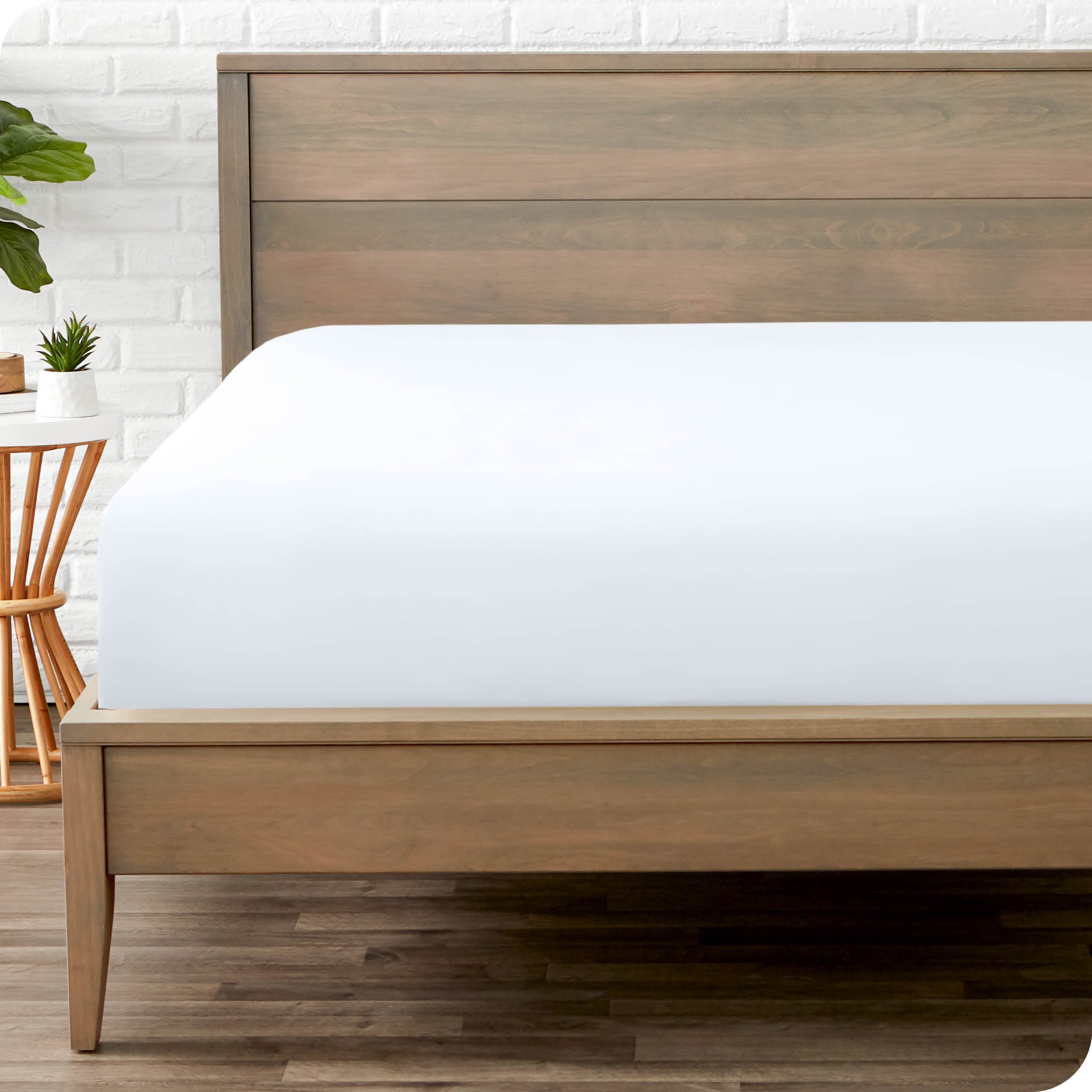 End of bed view with fitted sheet made on the mattress of a modern bed. 