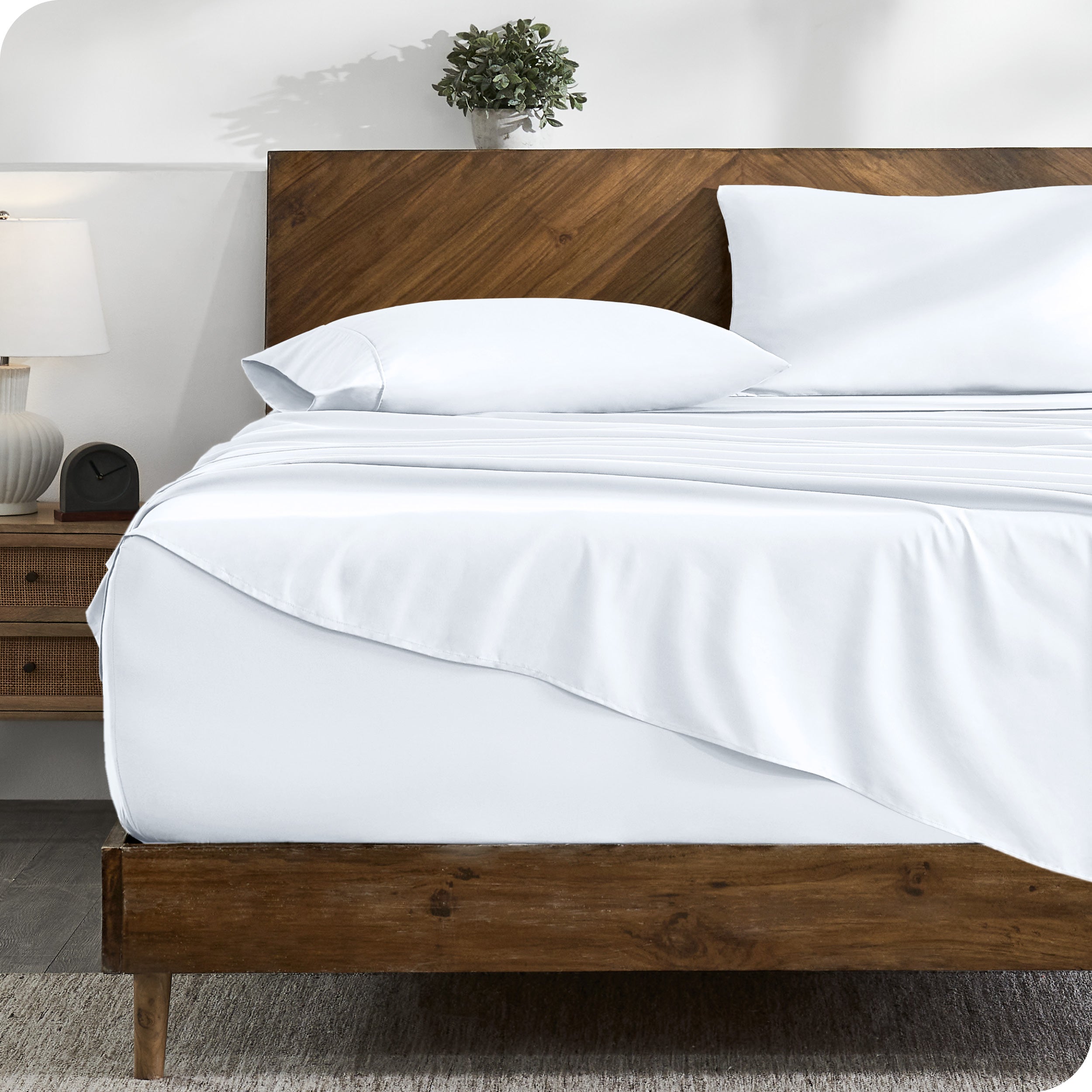 A cozy bedroom with a bed covered in soft microfiber sheets

