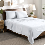 A stretch knit microfiber sheet set on a bed