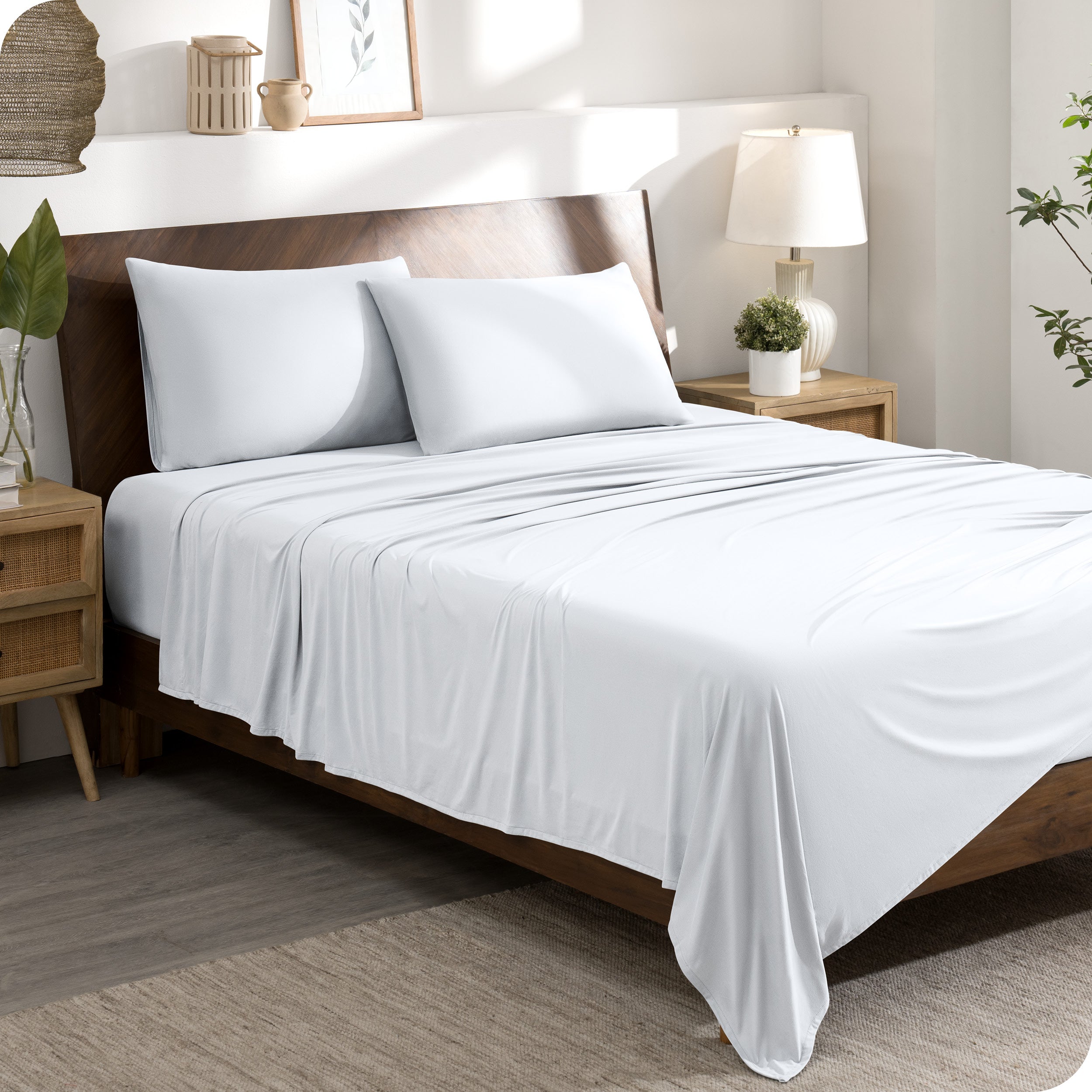 A stretch knit microfiber sheet set on a bed