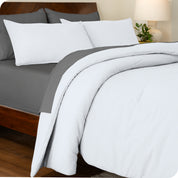 A side view of a bed made with a track stitch comforter set