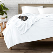 Microplush blanket laid out over a bed and folded back over itself