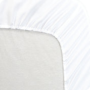 A mattress pad wrapped around the side and back of a mattress