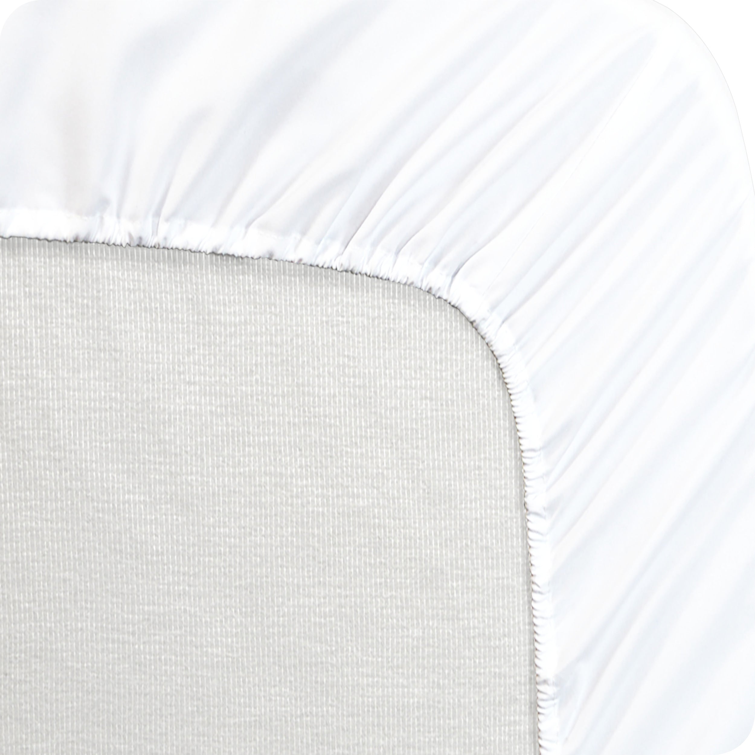 A mattress pad wrapped around the side and back of a mattress