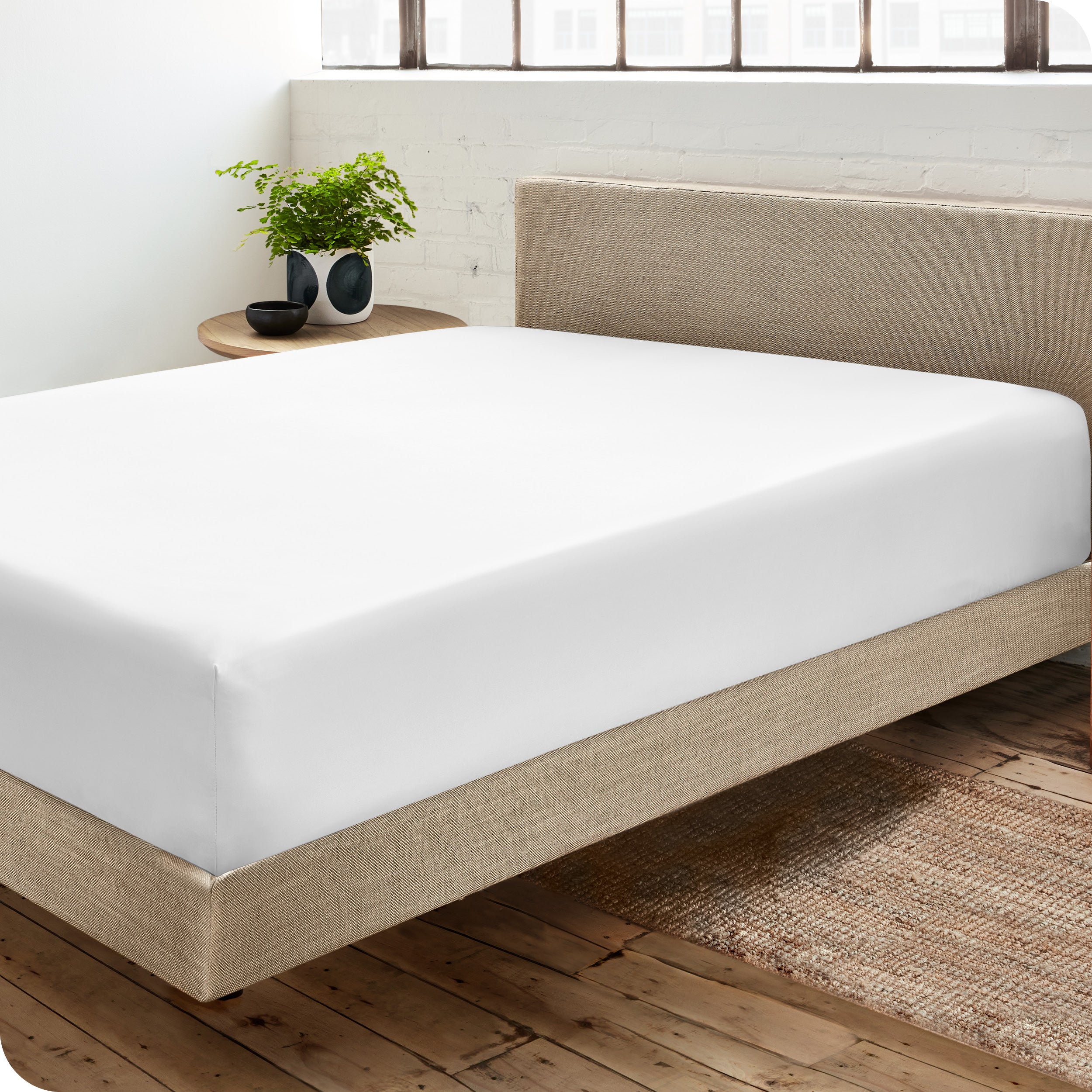 A sateen fitted sheet on a bed