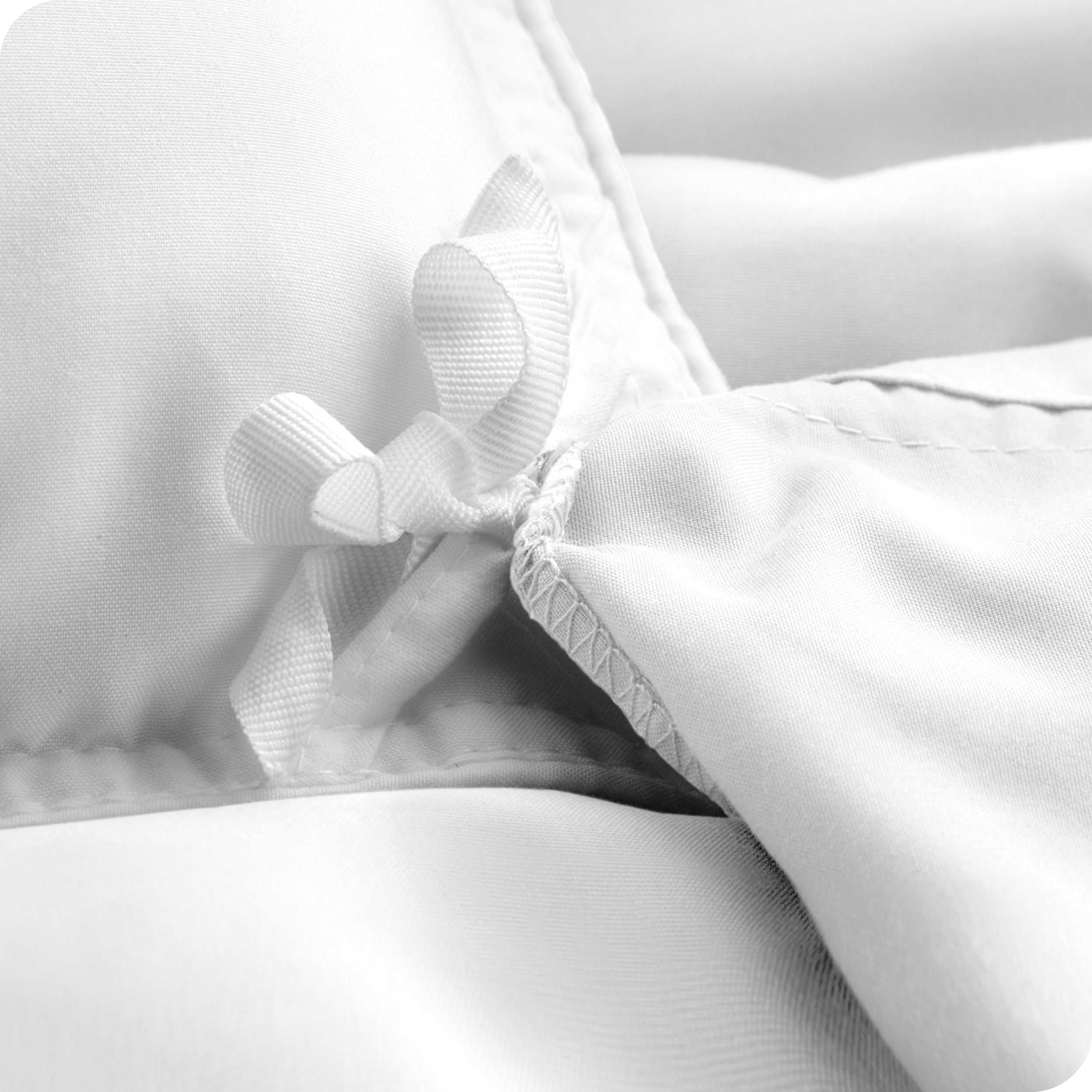 The corner ties of a duvet cover attached to a duvet insert