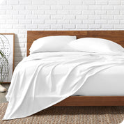 Organic jersey sheets on a bed with a wooden bed frame