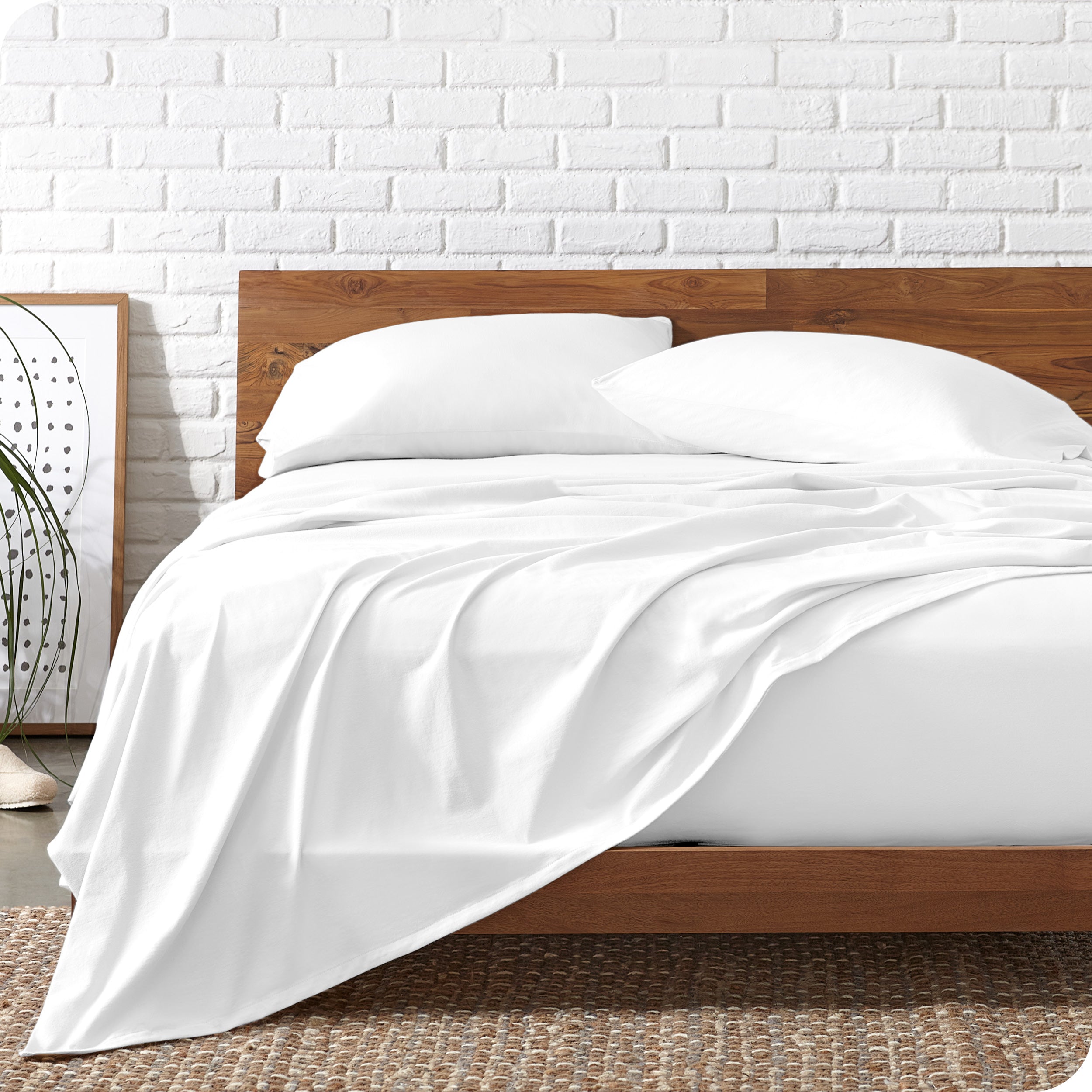 Organic jersey sheets on a bed with a wooden bed frame